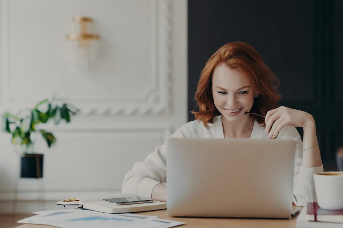 Positive happy female freelancer has busy working