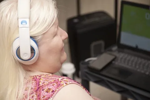 Blind woman listening headphones