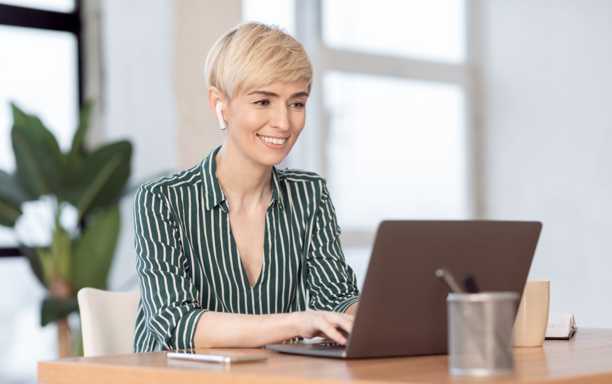 Our Client Support Response Times 1 mature lady working on laptop in earphones sitting 2025 03 18 19 12 04 utc